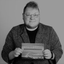 An image of Lawrence holding his printed book.